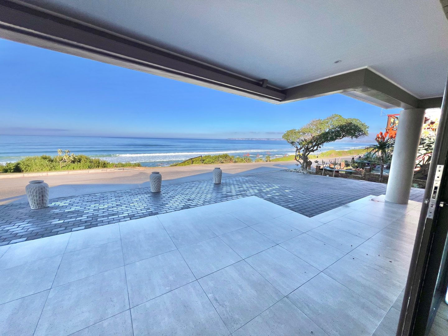The covered terrace at 431 Kusweg opening onto the dune and the sea