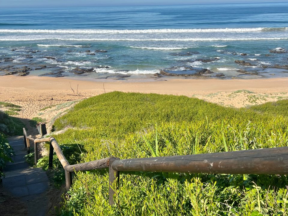 The wooden walkway from the property down to the beach