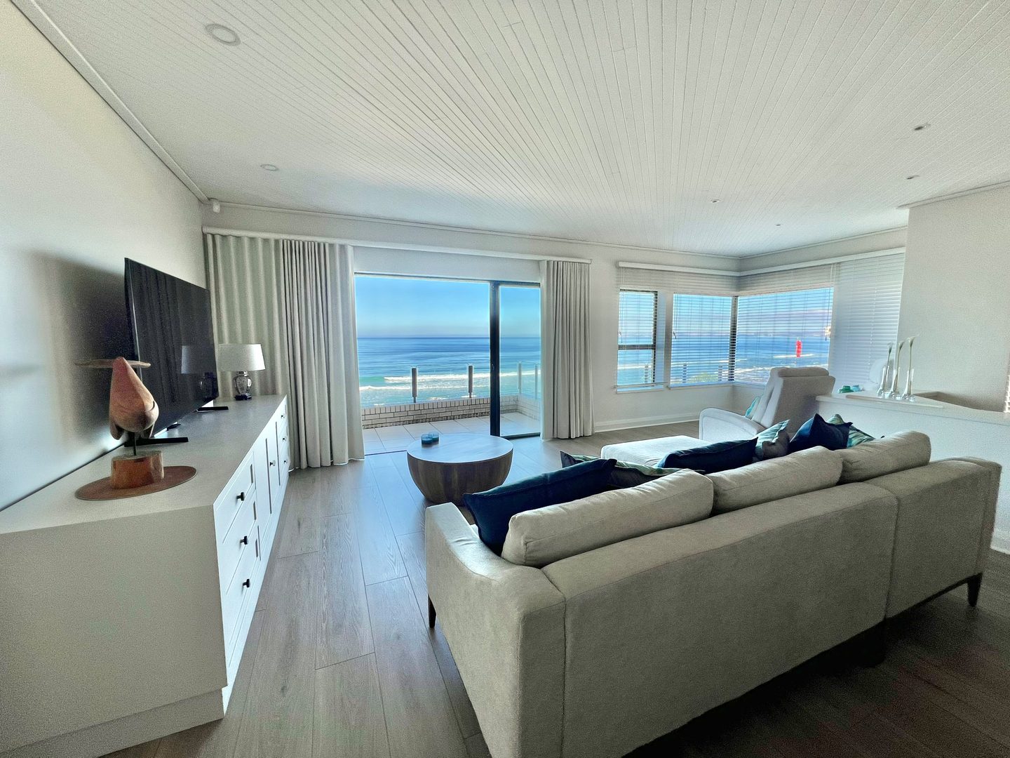 The upstairs lounge with floor-to-ceiling glass onto the sea
